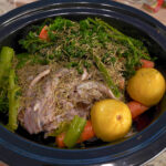 Crock pot full of chicken, vegetables, and seasonings