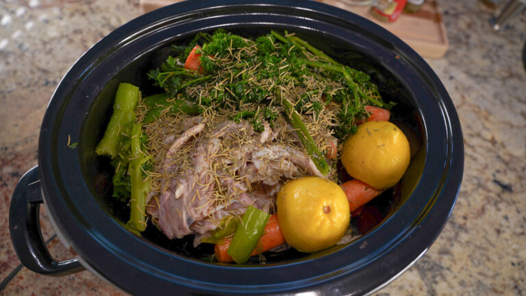 Crock pot full of chicken, vegetables, and seasonings