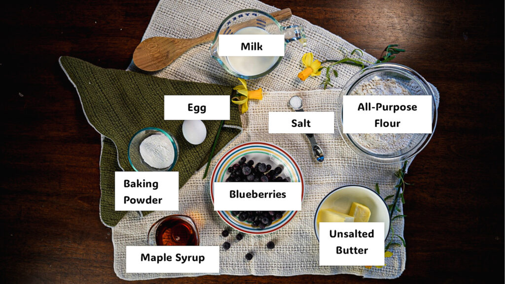Labeled ingredients for blueberry maple muffins with a cinnamon crumble
